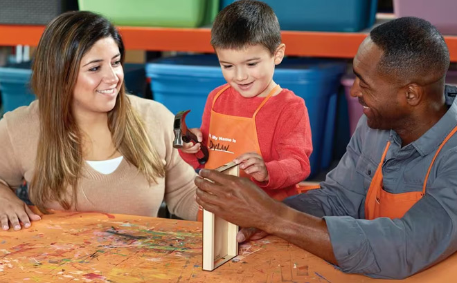 A Child holding a Hammer Creating a Blooming Picture Frame at Home Depot