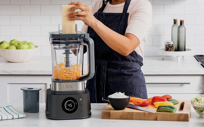 A lady using Ninja Foodi Power Blender Ultimate System